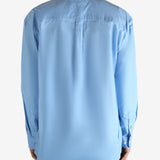 Blue shirt worn by a person, showing the shirt's fit