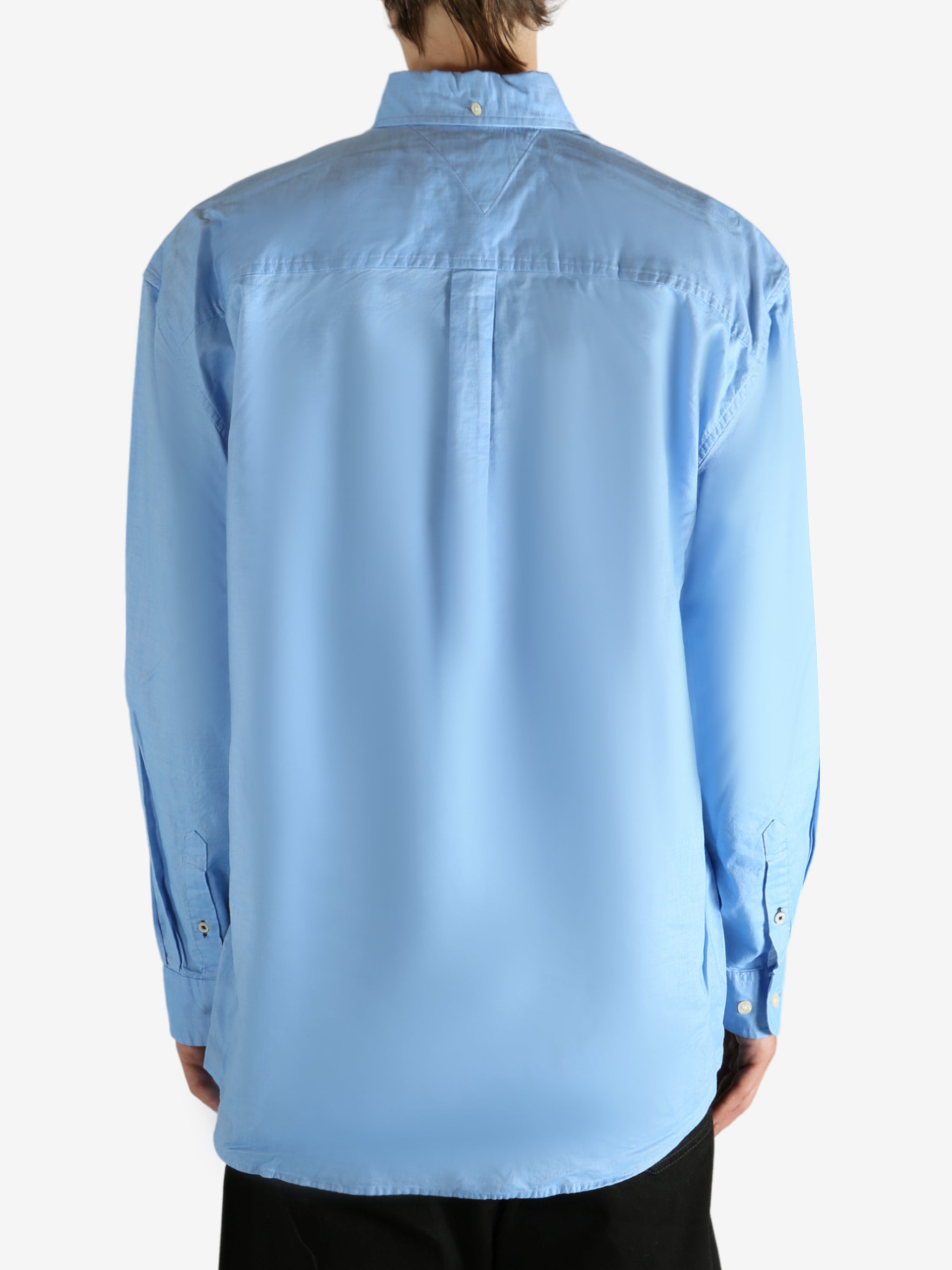 Blue shirt worn by a person, showing the shirt's fit
