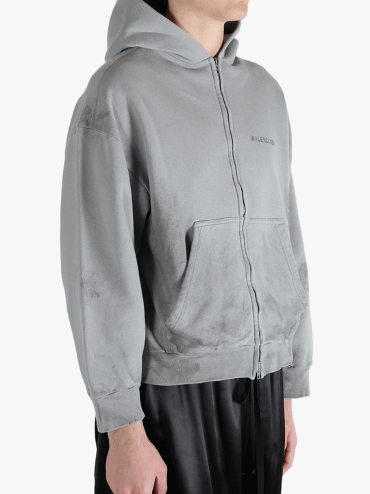 Grey hoodie worn by a person, showing the hoodies fit