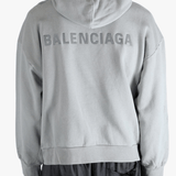 Grey hoodie worn by a person, showing the hoodies fit