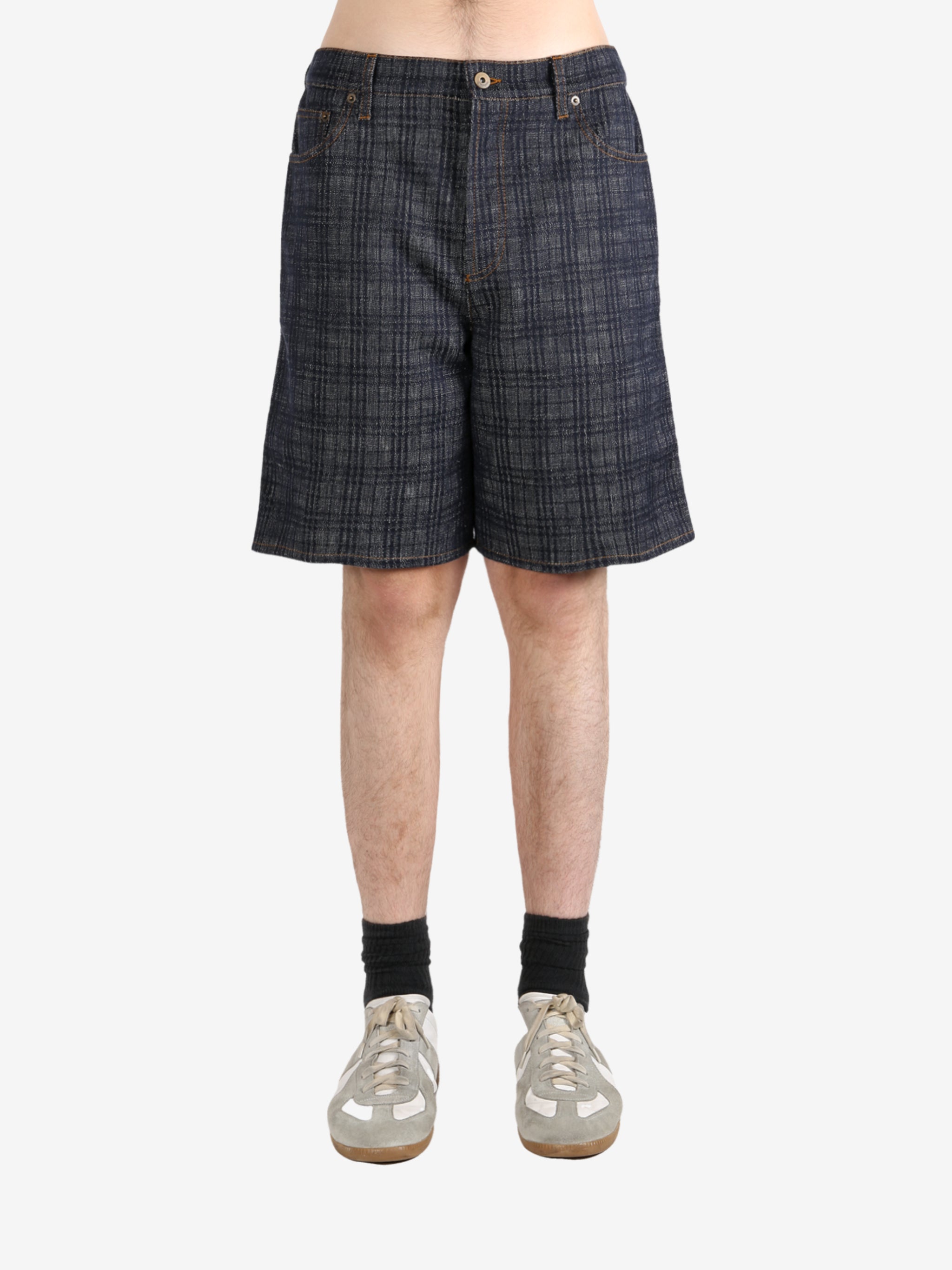 Black pants worn by a person, showing the pants fit