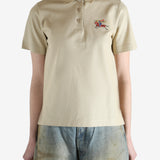 Beige polo shirt worn by a person, showing the shirt fit