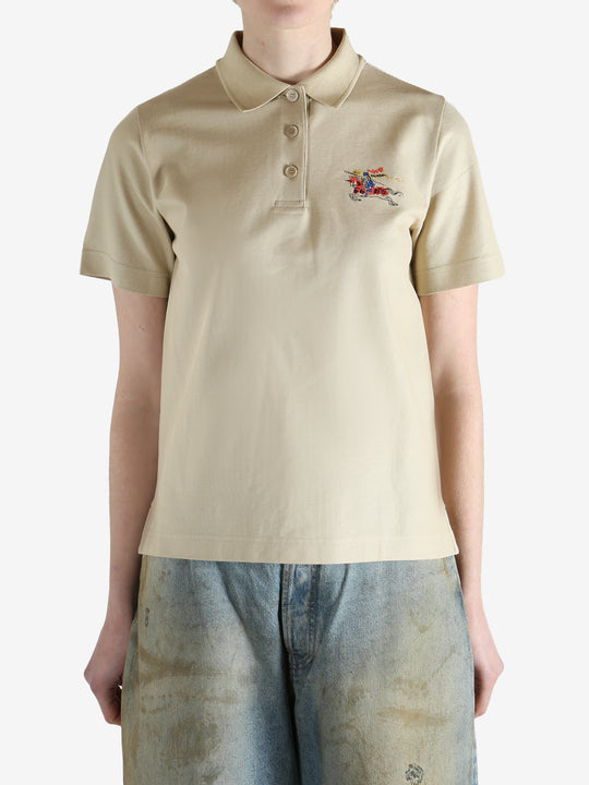 Beige polo shirt worn by a person, showing the shirt fit