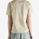 Beige polo shirt worn by a person, showing the shirt fit