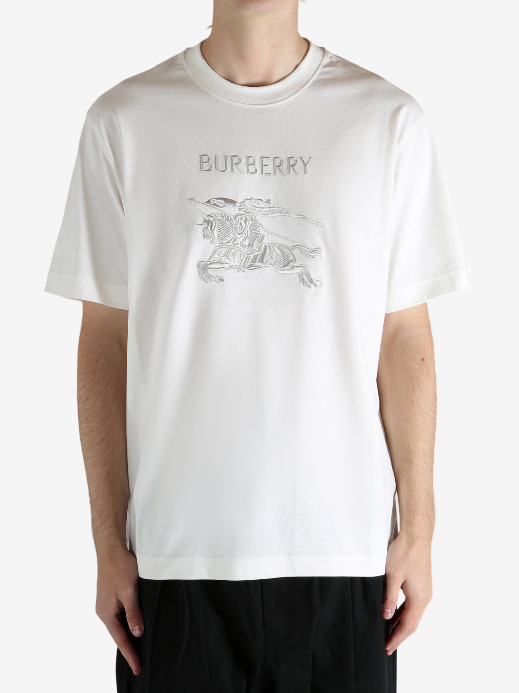 White t-shirt worn by a person, showing the t-shirt's fit