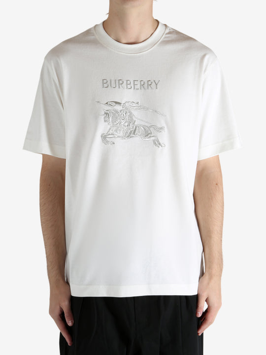 White t-shirt worn by a person, showing the t-shirt's fit