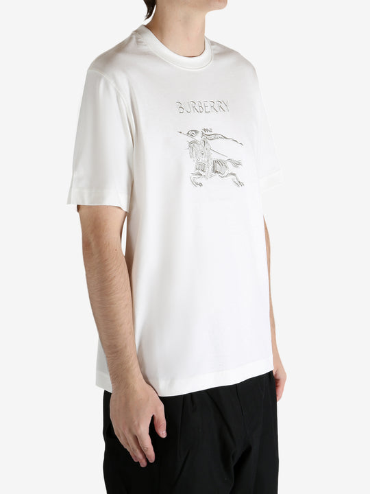 White t-shirt worn by a person, showing the t-shirt's fit