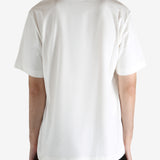 White t-shirt worn by a person, showing the t-shirt's fit