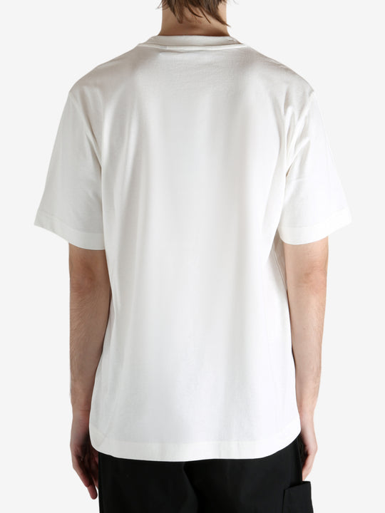 White t-shirt worn by a person, showing the t-shirt's fit