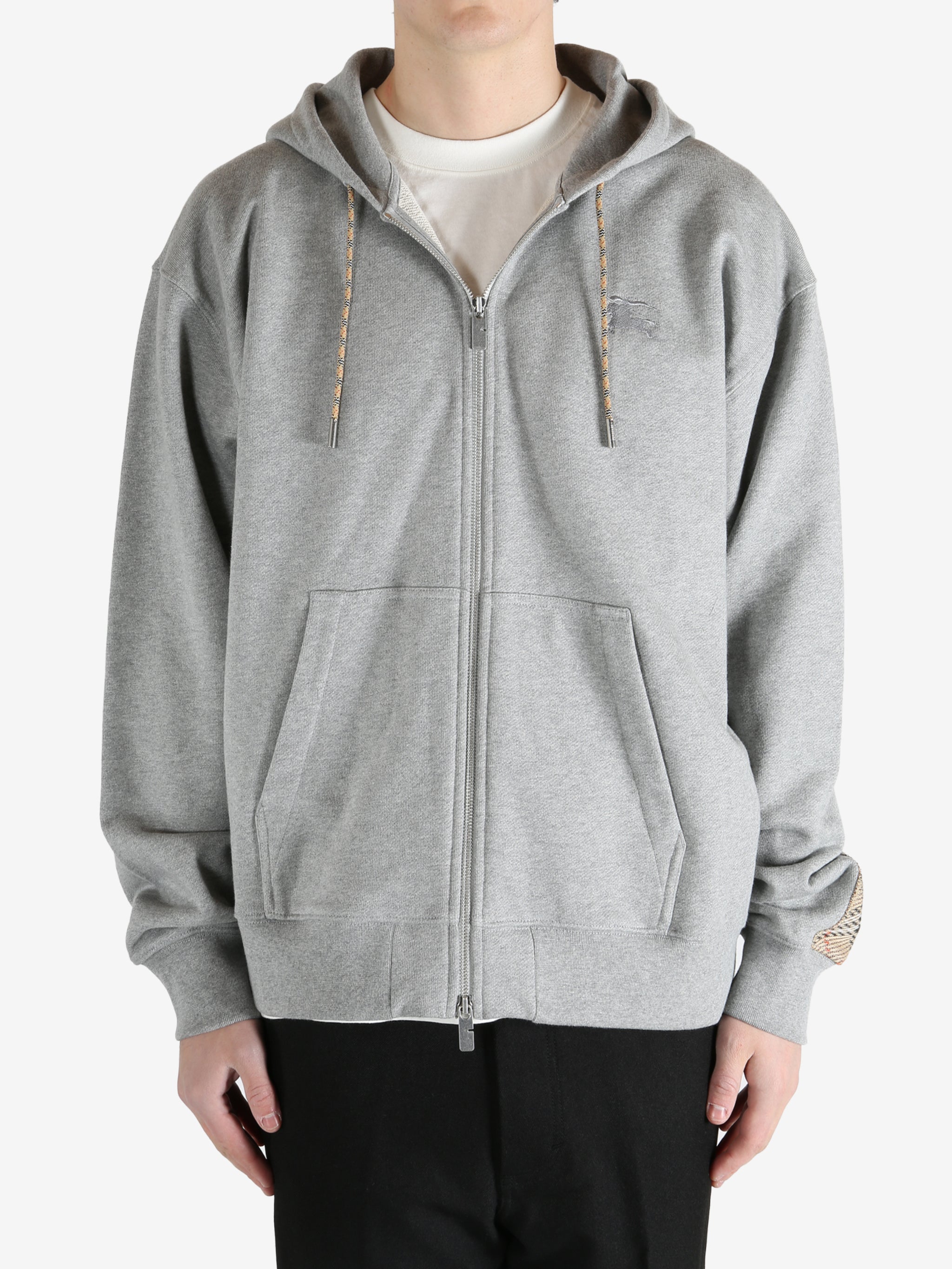  Grey jacket worn by a person, showing the jacket fit