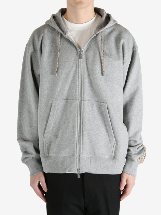  Grey jacket worn by a person, showing the jacket fit