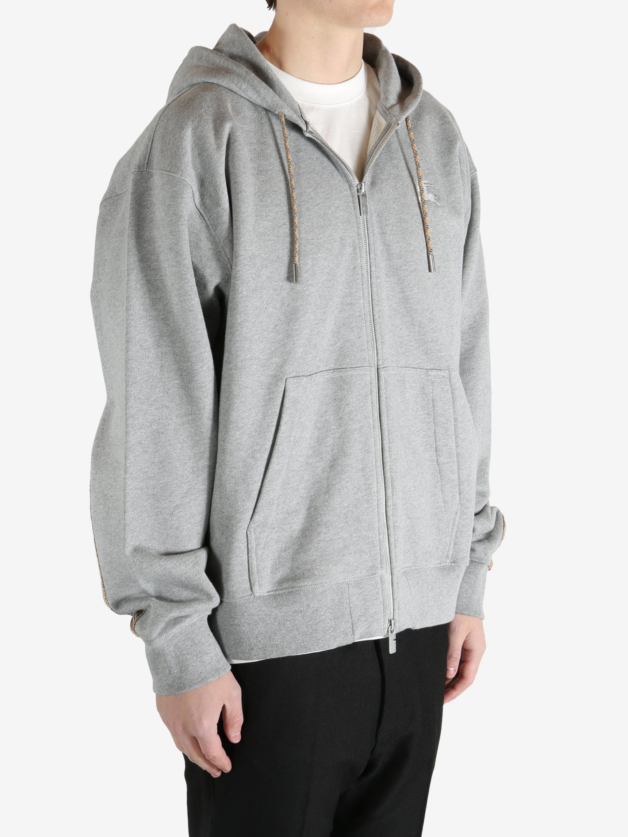  Grey jacket worn by a person, showing the jacket fit