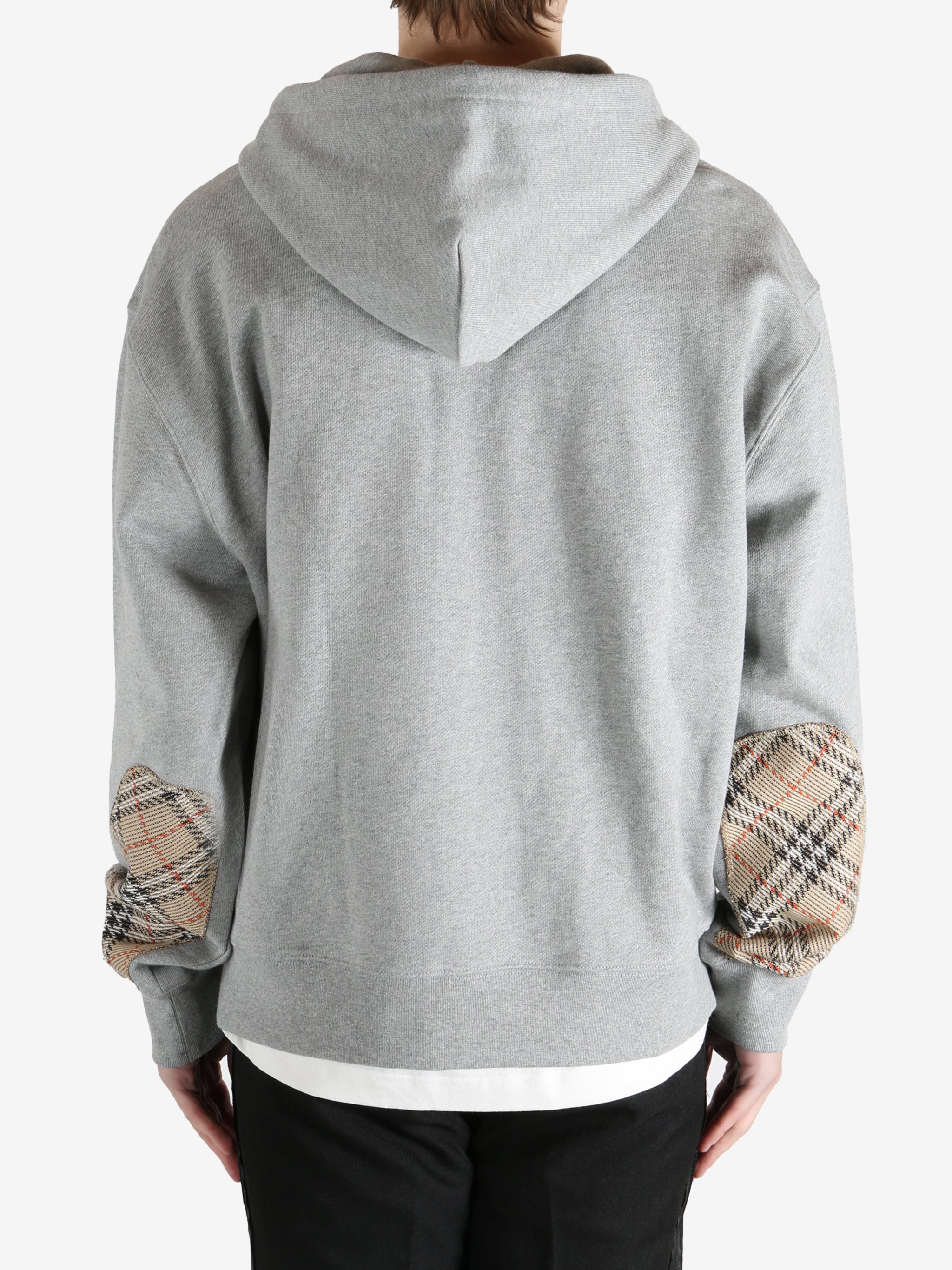  Grey jacket worn by a person, showing the jacket fit