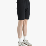 Black short worn by a person, showing the short's fit