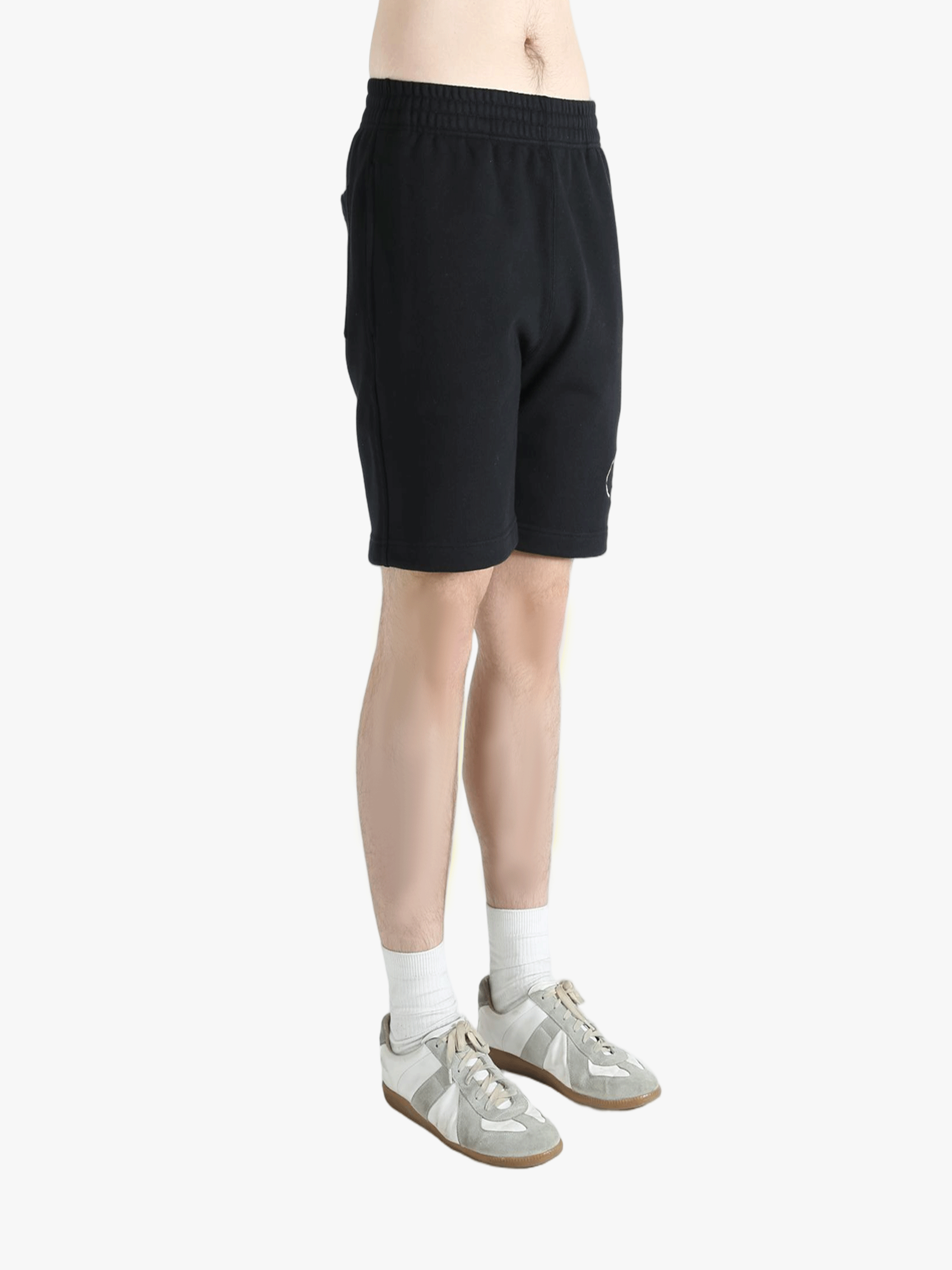 Black short worn by a person, showing the short's fit