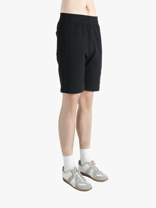 Black short worn by a person, showing the short's fit
