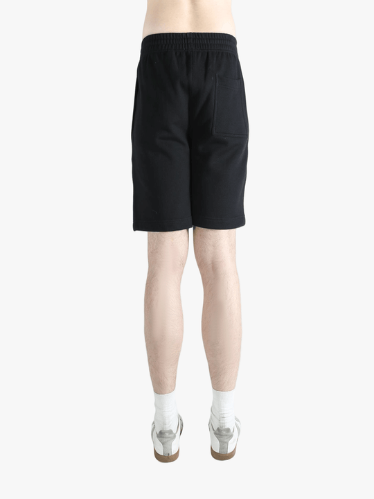 Black short worn by a person, showing the short's fit