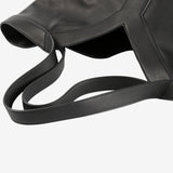 Close up of black bags,showing texture of the leather fabric.