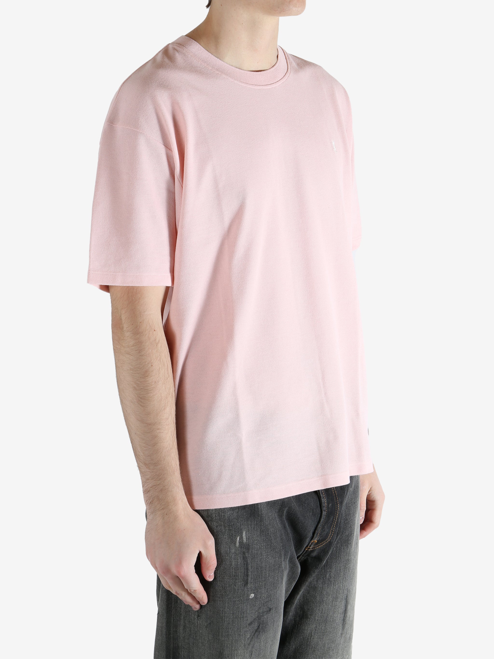 Pink t-shirts worn by a person, showing the shirt's fit