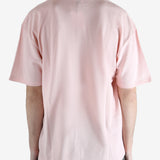 Pink t-shirts worn by a person, showing the shirt's fit