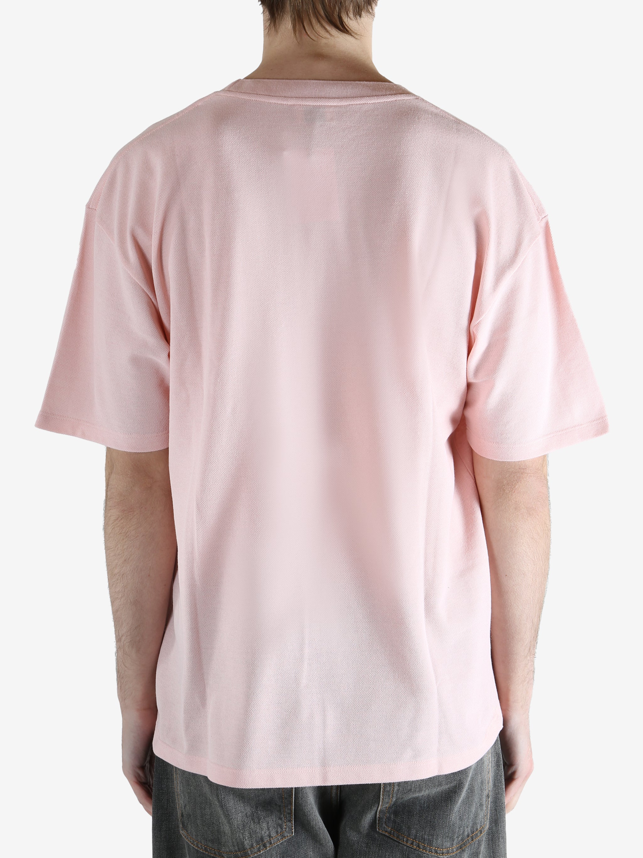 Pink t-shirts worn by a person, showing the shirt's fit