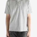 Grey shirt worn by a person, showing the shirt's fit