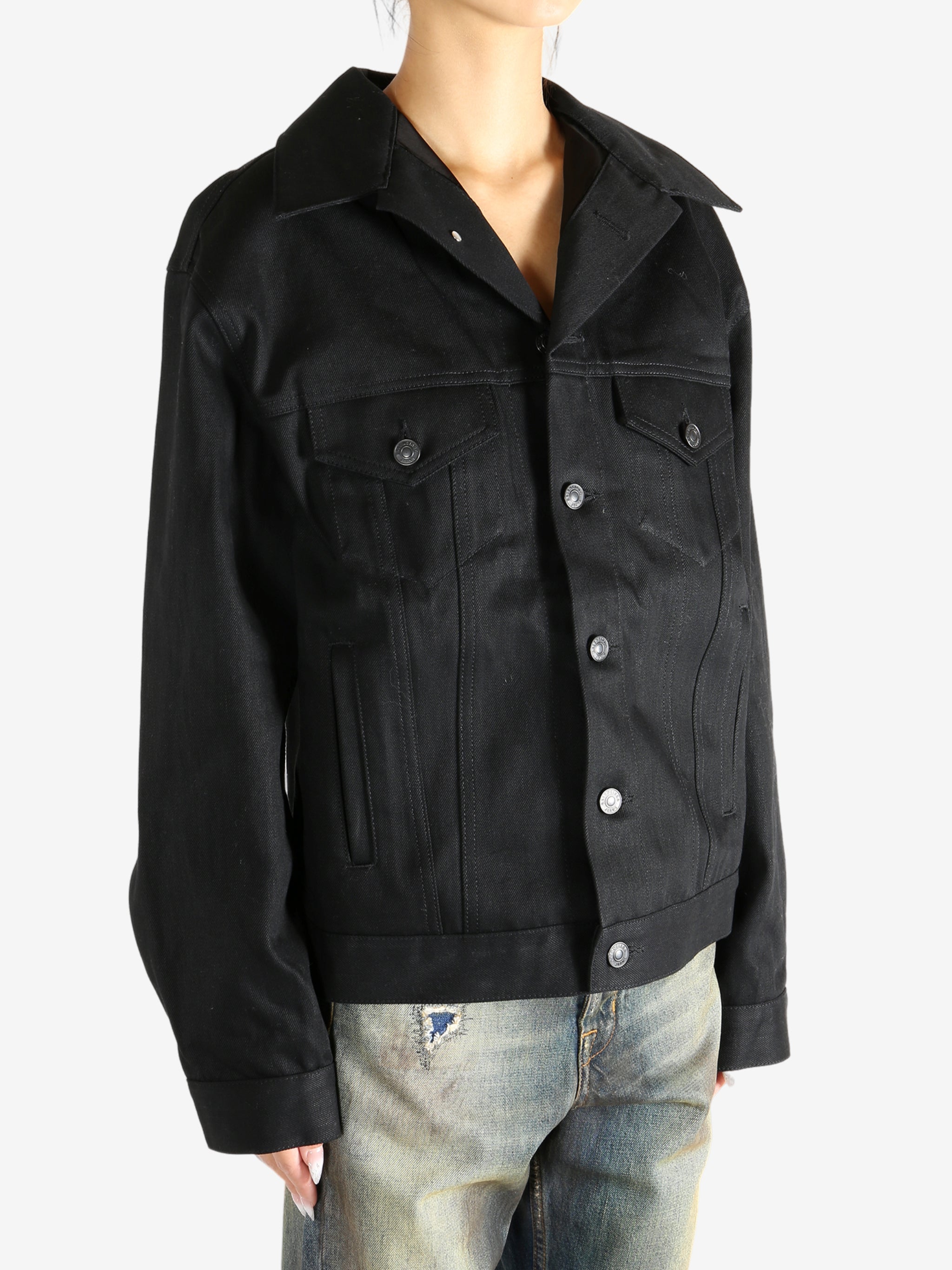 black jacket worn by a person, showing the jacket fit