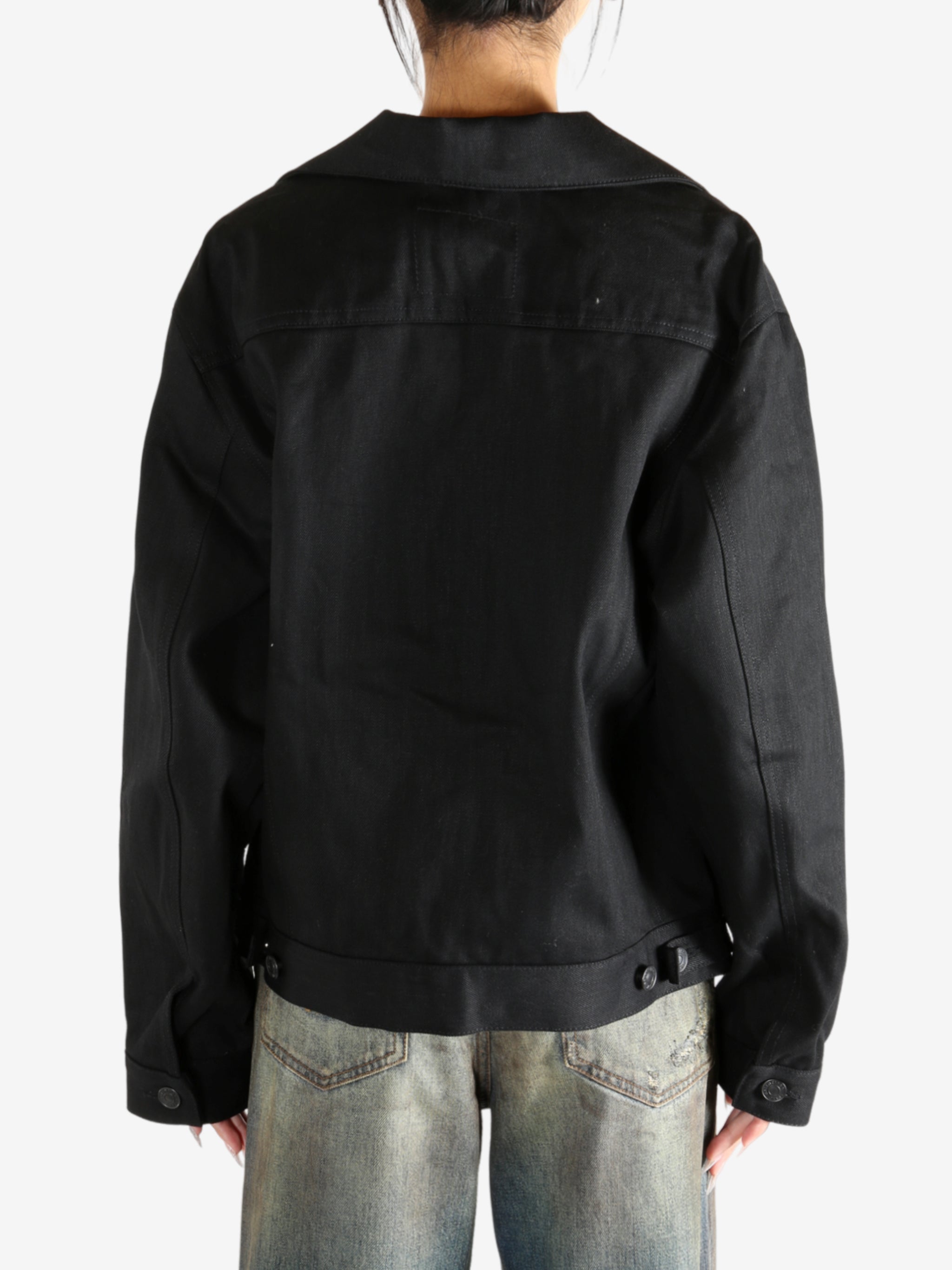 black jacket worn by a person, showing the jacket fit