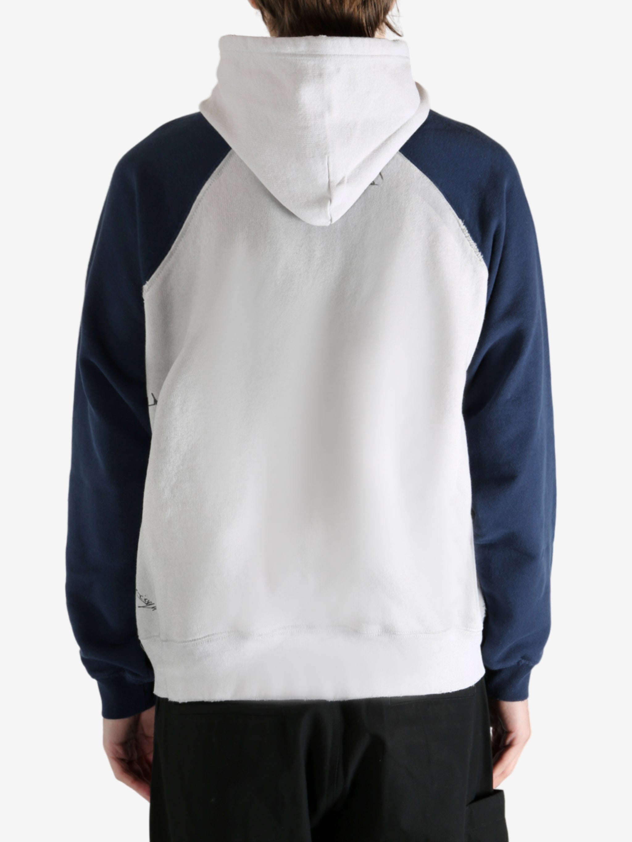 White hoodie worn by a person, showing the hoodie's fit