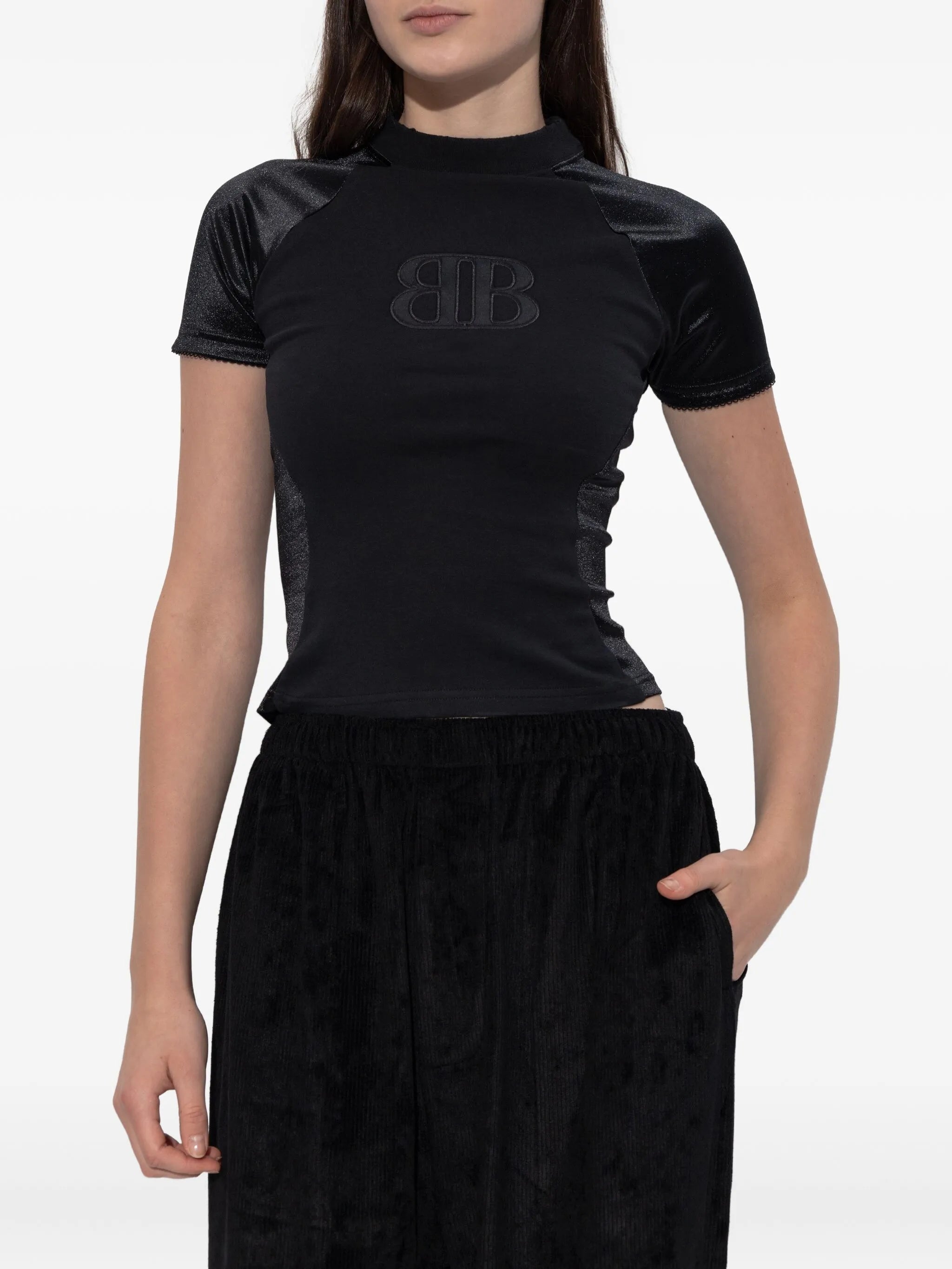 Black t shirt  worn by a person, showing the t shirt's fit