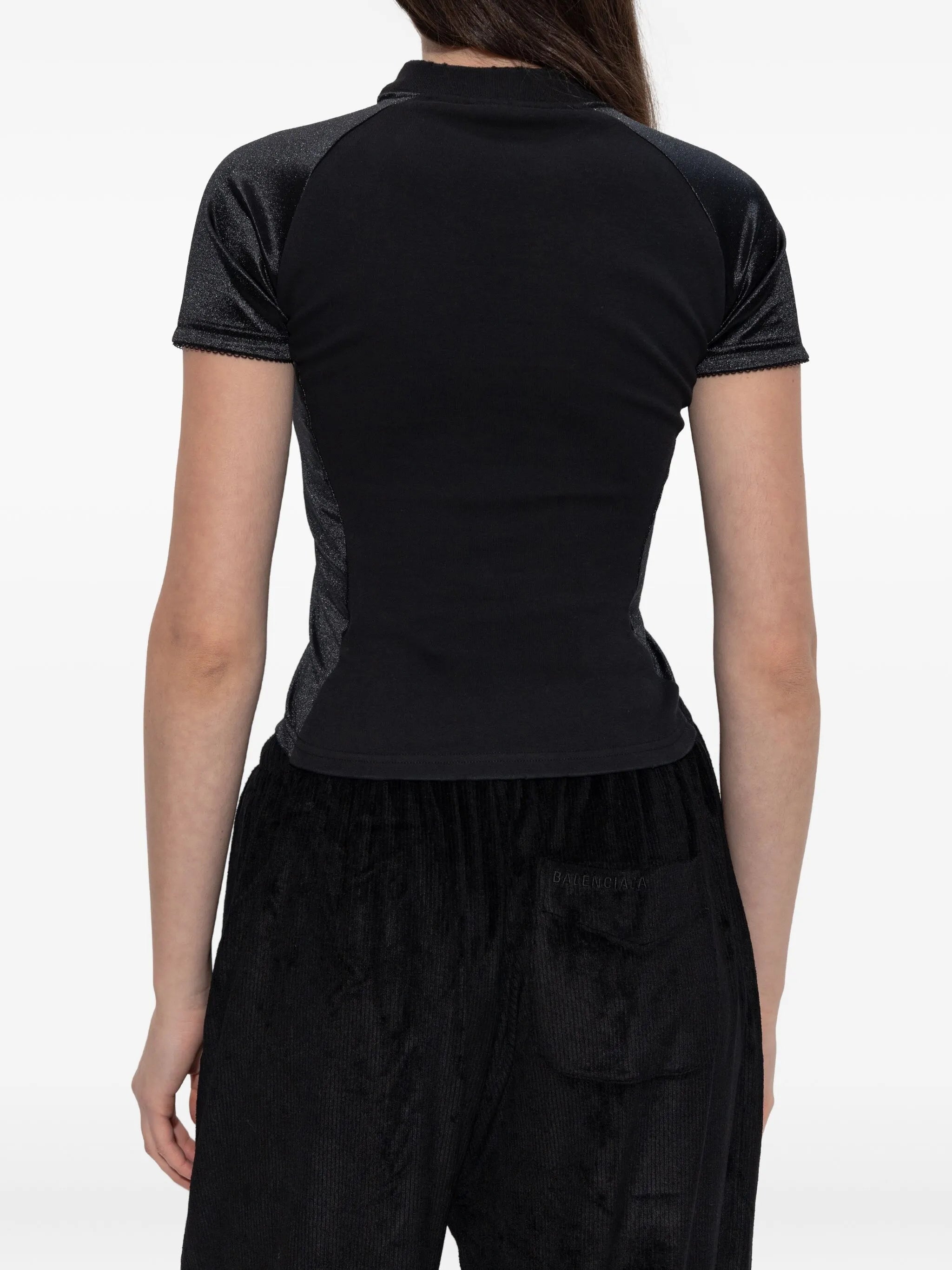 Black t shirt  worn by a person, showing the t shirt's fit