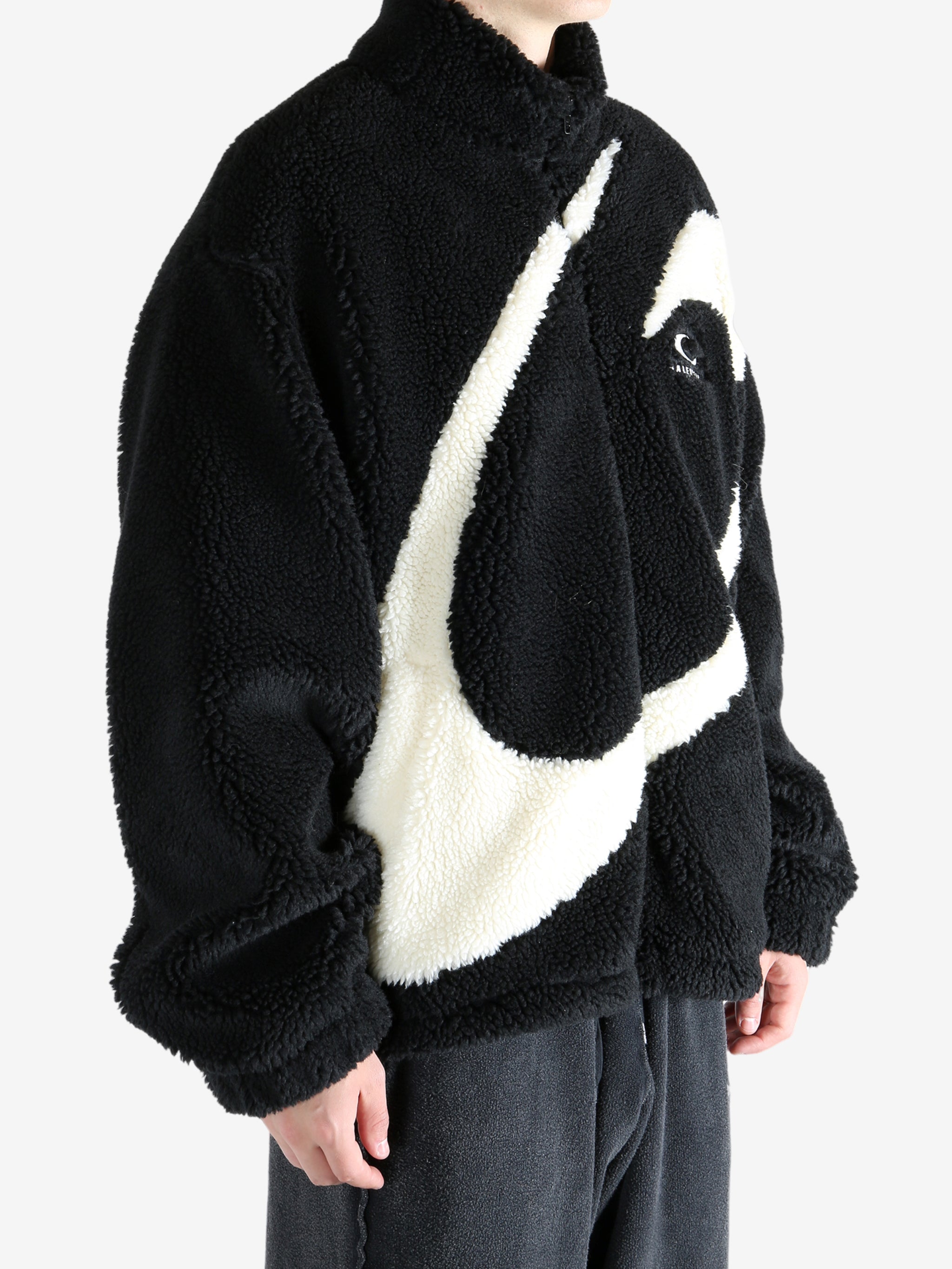 Black jacket worn by a person, showing the jacket's fit