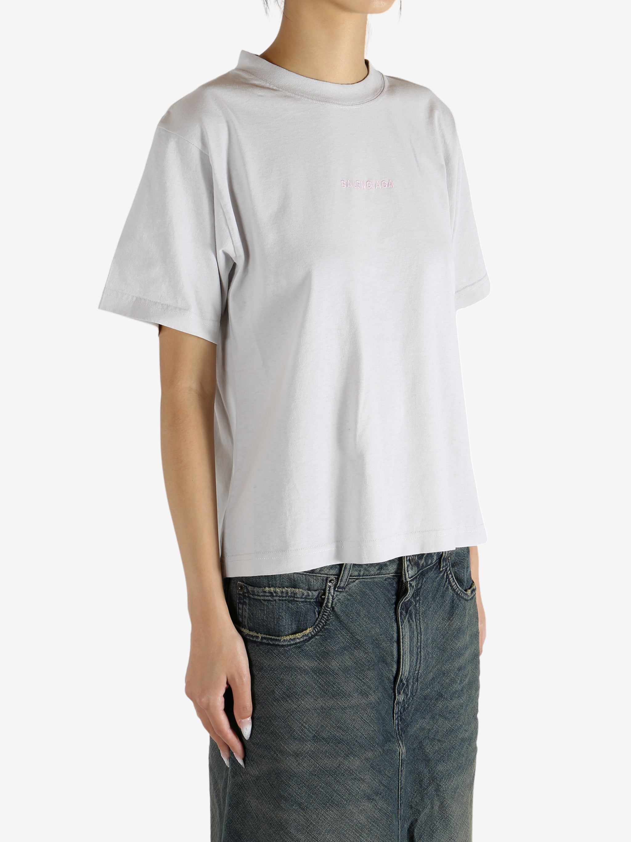 White t-shirt worn by a person, showing the shirt's fit
