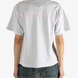 White t-shirt worn by a person, showing the shirt's fit