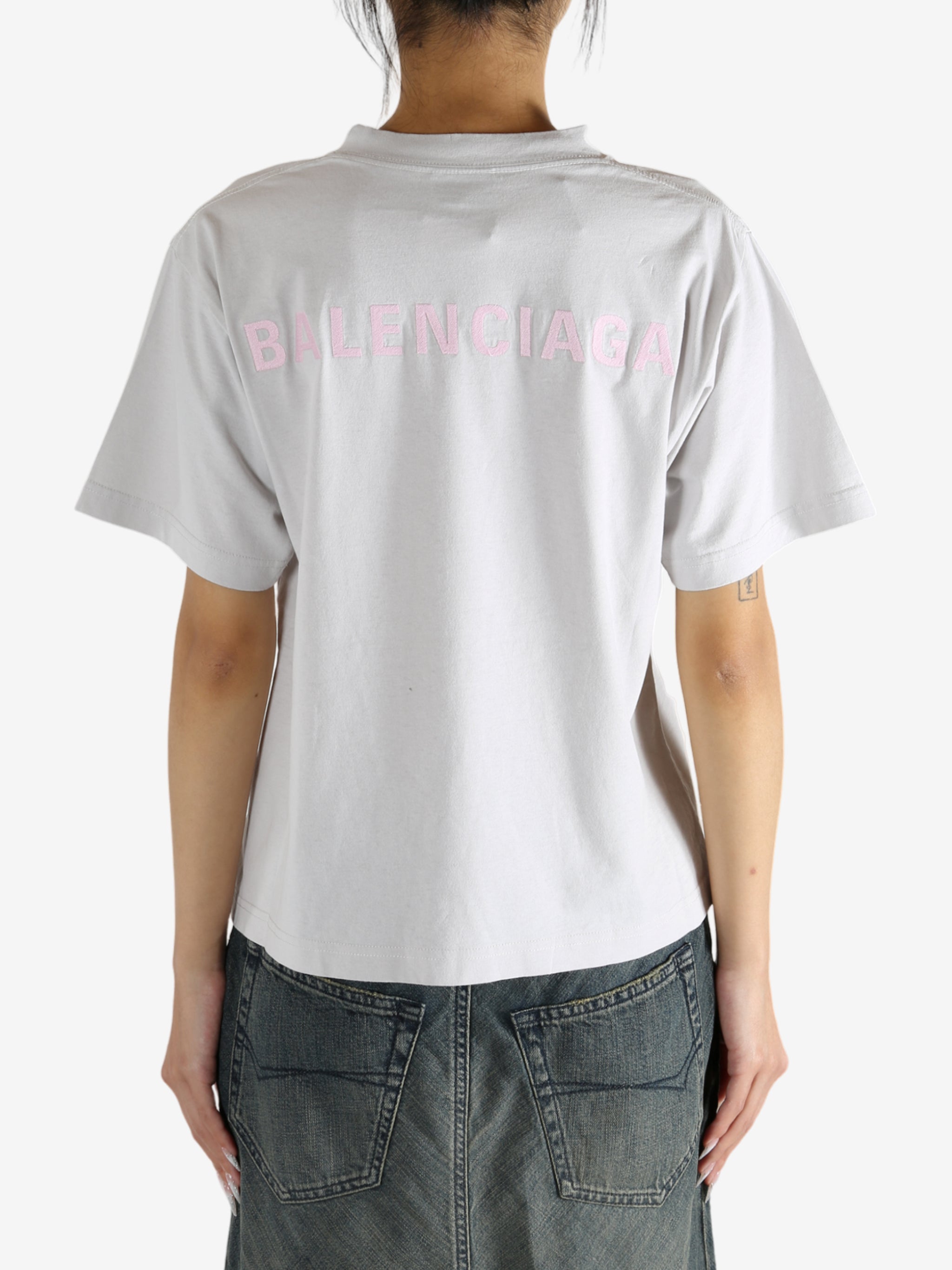 White t-shirt worn by a person, showing the shirt's fit