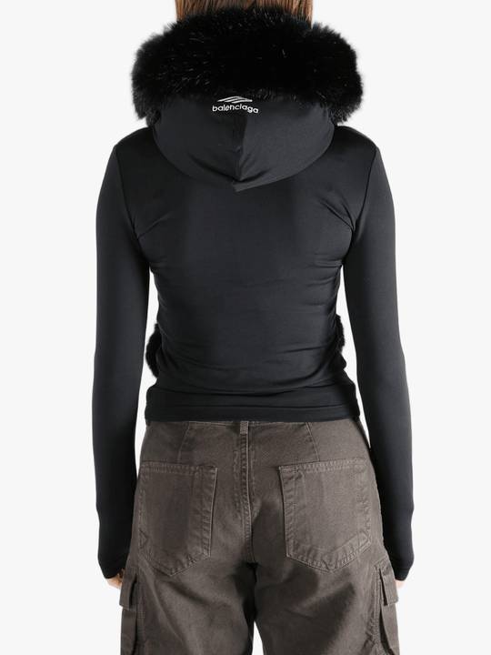 Black top  worn by a person, showing the top 's fit