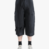 Black pants worn by a person, showing the pants' fit