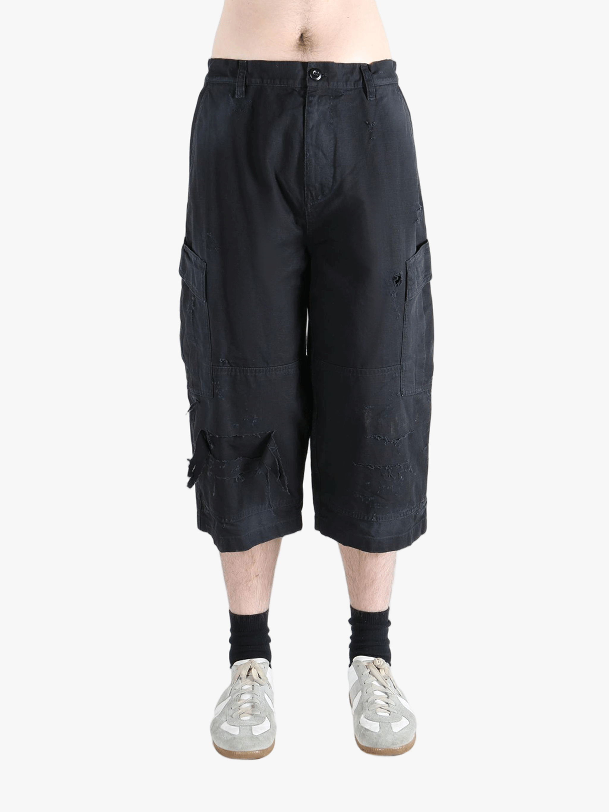 Black pants worn by a person, showing the pants' fit