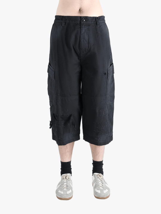 Black pants worn by a person, showing the pants' fit