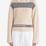Tan knitwear worn by a person, showing the knitwear fit