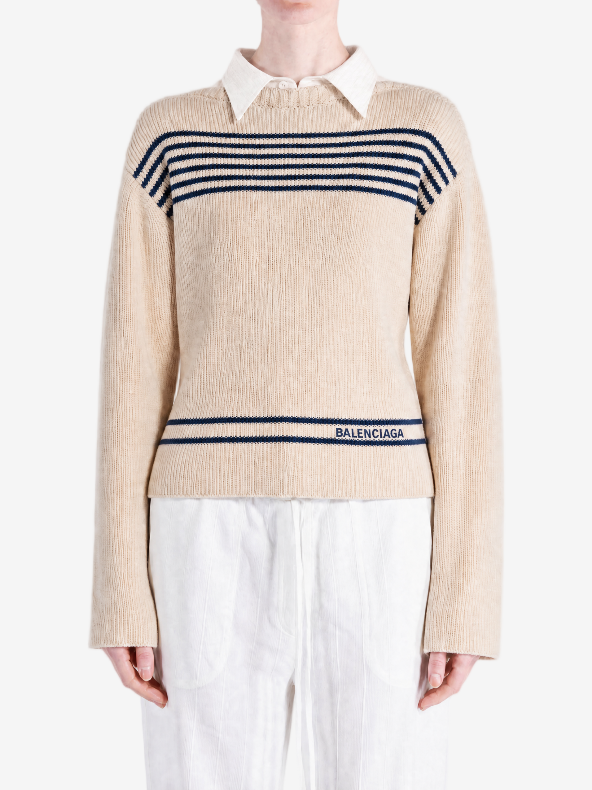 Tan knitwear worn by a person, showing the knitwear fit