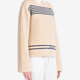 Tan knitwear worn by a person, showing the knitwear fit