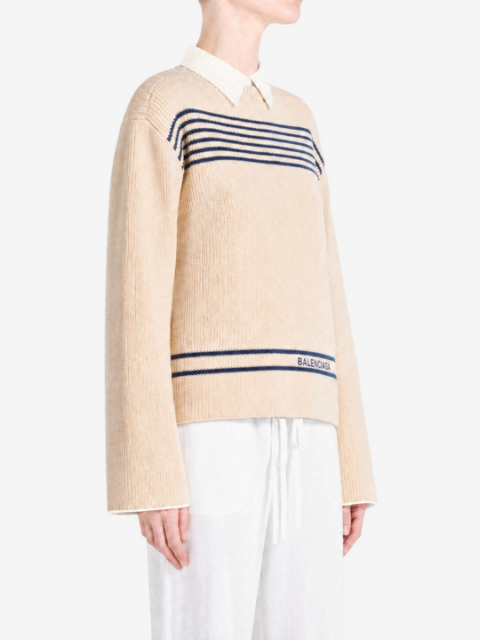 Tan knitwear worn by a person, showing the knitwear fit