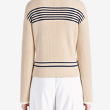Tan knitwear worn by a person, showing the knitwear fit