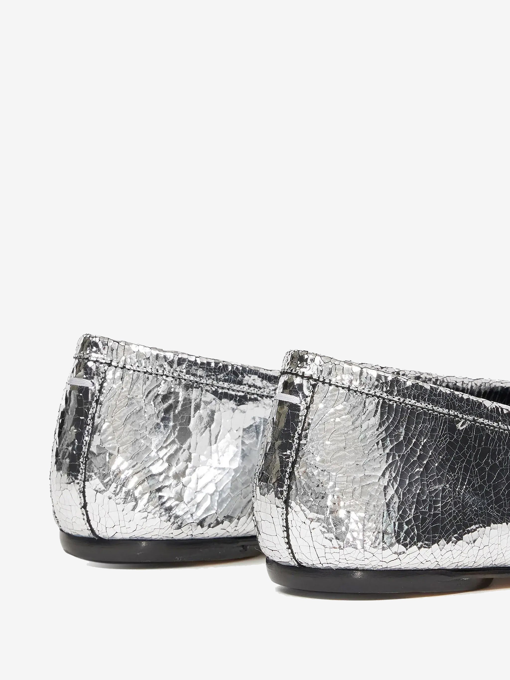 Close up of grey shoes, showing texture of the leather fabric