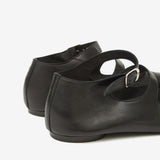 Close up of black shoes, showing texture of the leather fabric