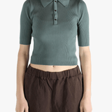 Green polo worn by a person, showing the polo's fit