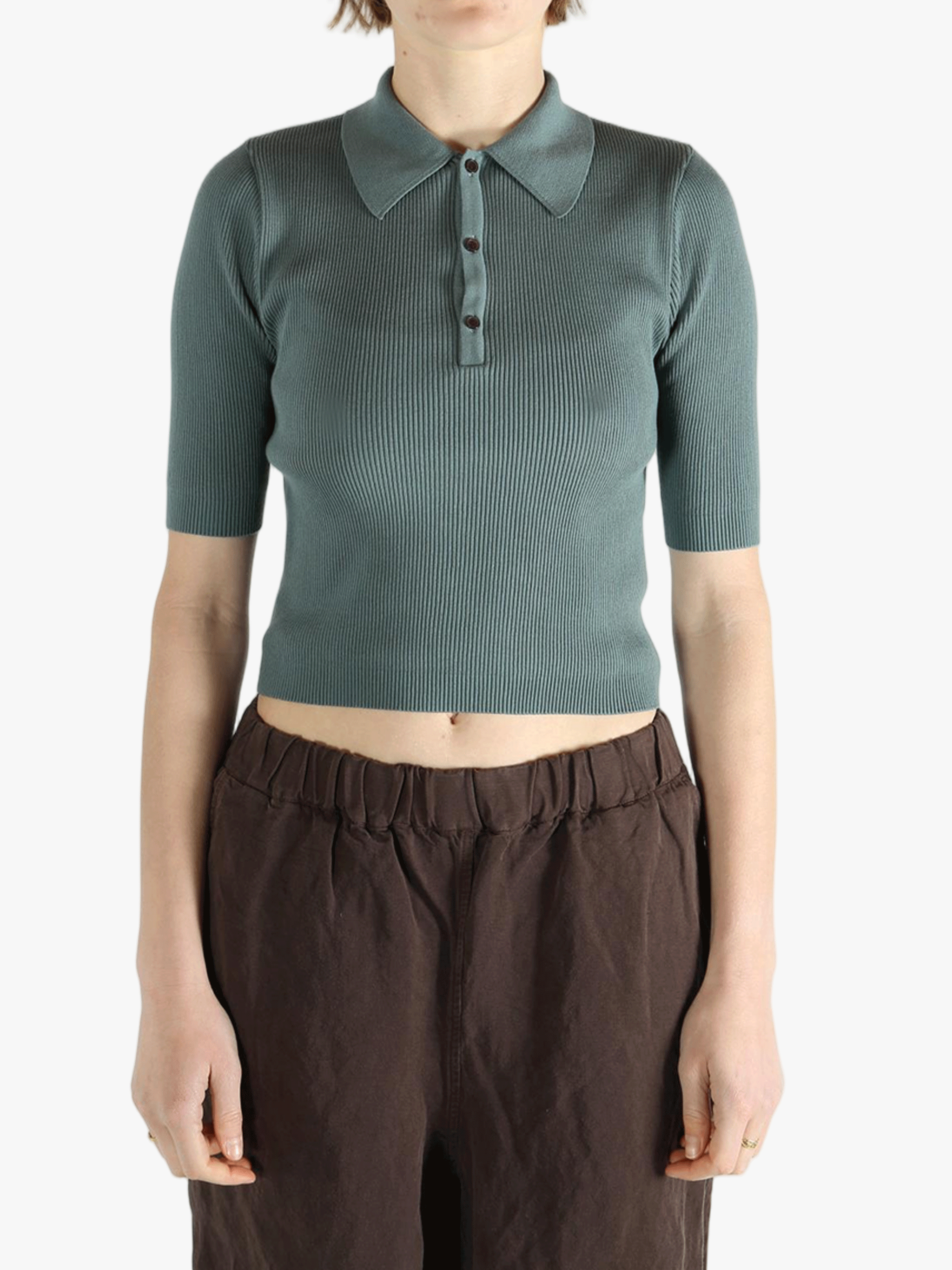 Green polo worn by a person, showing the polo's fit