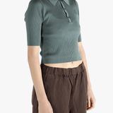 Green polo worn by a person, showing the polo's fit