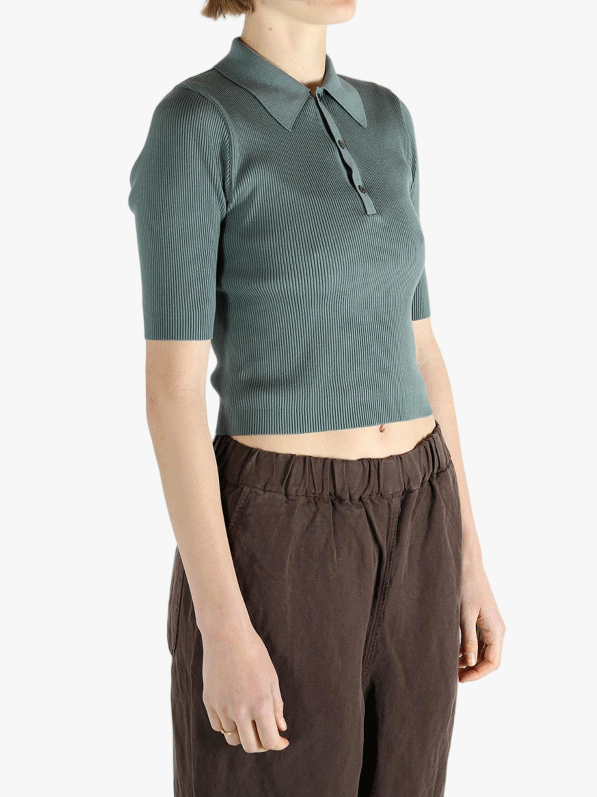 Green polo worn by a person, showing the polo's fit